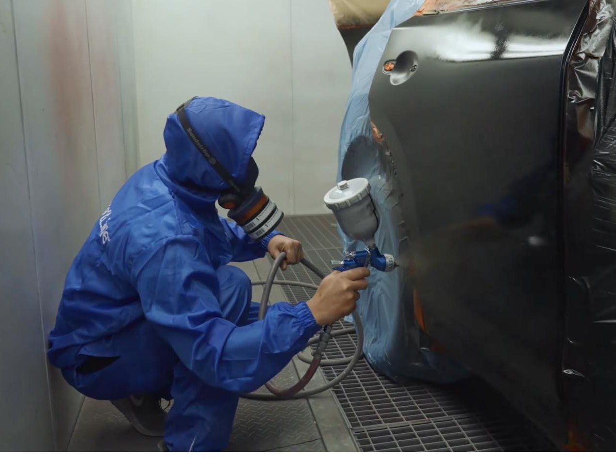 CrashClaim technician refinishing a repaired vehicle in NSW